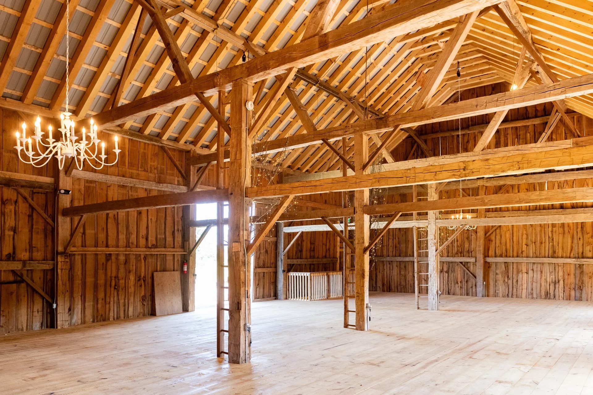 Interior of the rugged timber barn where Refuge Ridge Fellowship gathers in Primm Springs, Tennessee